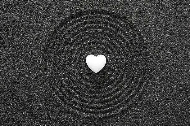 Photo of Japanese ZEN garden with white heart in raked sand