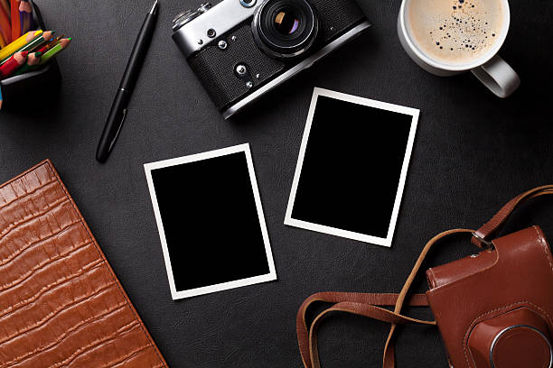istock Office desk with photos, camera, coffee and notepad 519528664