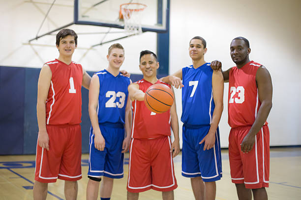 istock Basketball players in uniforms posing together 519529112