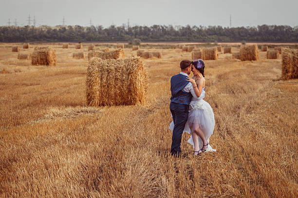 istock bride and groom with veil near hay 519529236