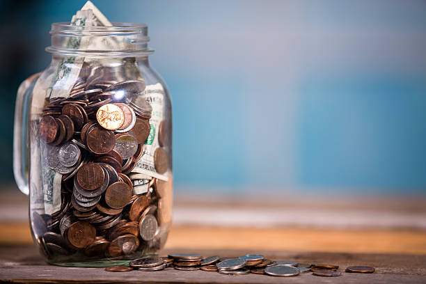 istock Money jar with U.S. currency.  Savings, donations concepts. 519529323