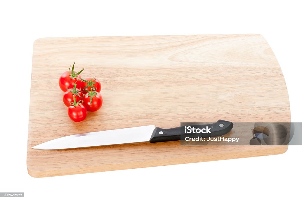 Organic Tomatoes and Knife Organic Tomatoes and Knife on Cutting Board. Close-up Stock Photo