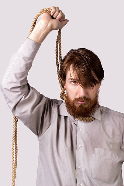 istock Young bearded man with a rope around his neck 519530688