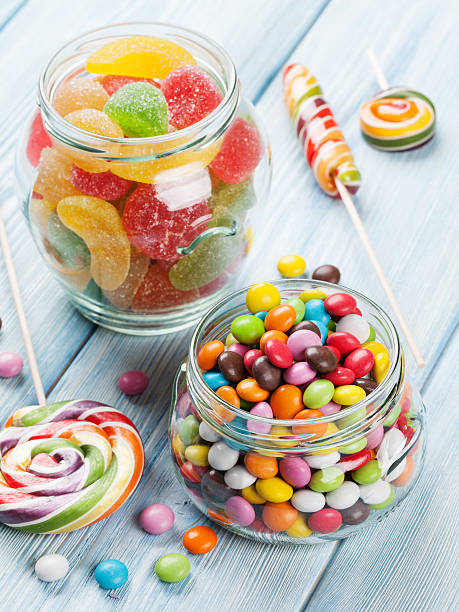 istock Colorful candies on wooden background 519530826