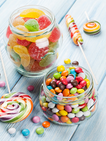 Colorful candies on wooden table background