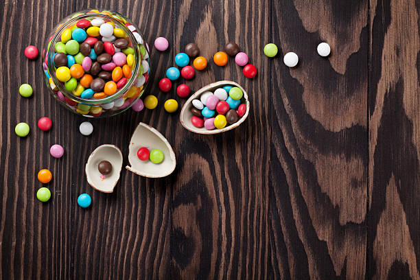 istock Colorful candies on wooden background 519530900