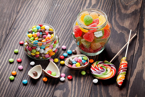 istock Colorful candies on wooden background 519531374