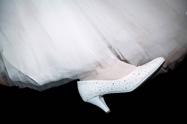 istock Shoes white of the bride on her leg 519531432