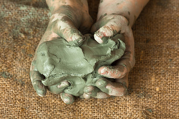 hands of child with blue clay, closeup