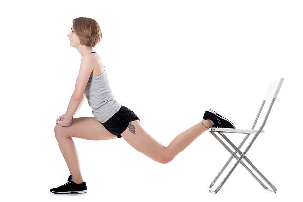 Sporty woman fitness training Young cheerful sporty attractive woman doing fitness training, exercises for hips and buttocks with office chair, full length isolated studio image on white background pics of girls buttocks stock pictures, royalty-free photos & images
