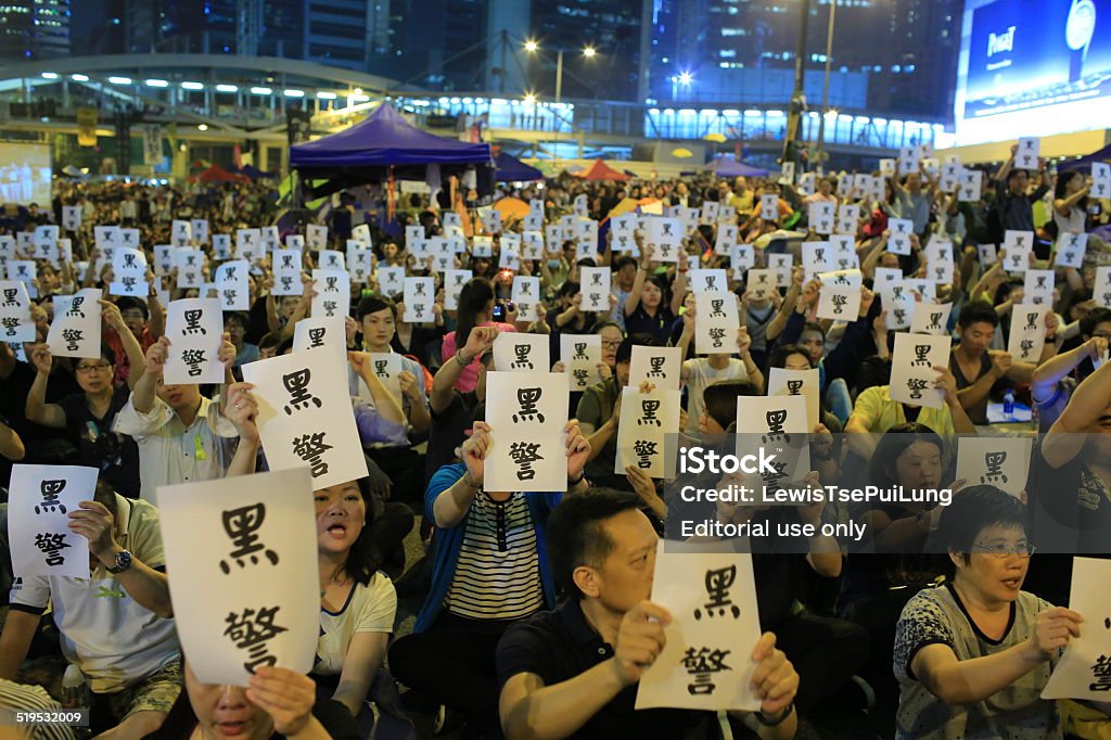 Umbrella revolution: black police Hong Kong, Сhina - October 15, 2014: people pick up the word " black police"  in umbrella revolution near admiralty government offices in Admiralty. Umbrella revolution after two week, Media report that police beat up a armless protester in a dark corner during protest. people call into question about the police illegally abuse their power Asia Stock Photo