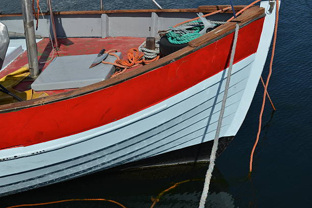 A fishing boat with several pieces of equipment including  knife