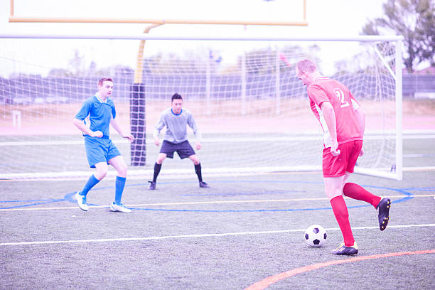 istock Kicking a Ball at the Net 519533344