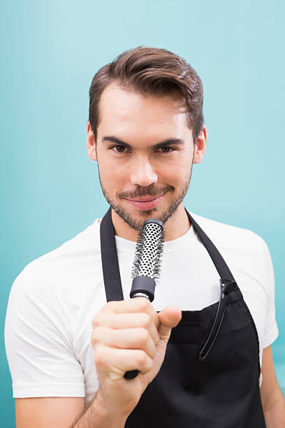 istock Handsome hair stylist smiling at camera 519533441