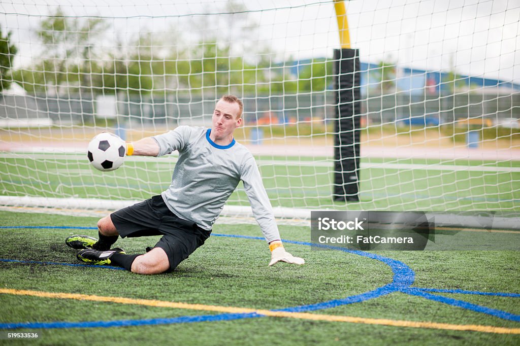 Goalie Blocking the Shot A goalie is stopping the ball from going in the net during a game. Active Lifestyle Stock Photo