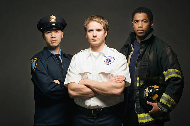 Police officer, paramedic, and fireman on black background, port Police officer, paramedic, and fireman on black background, portrait police and firemen stock pictures, royalty-free photos & images