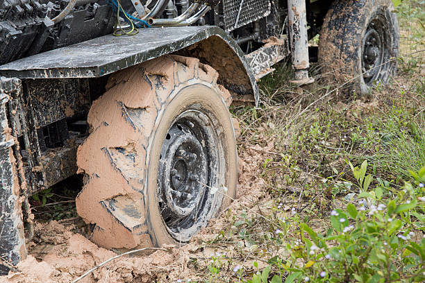 istock Car's wheels in mud in the forest 519534957