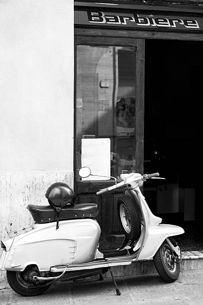Old "Lambretta" motorcycle out of a barber shop. BW image stock photo