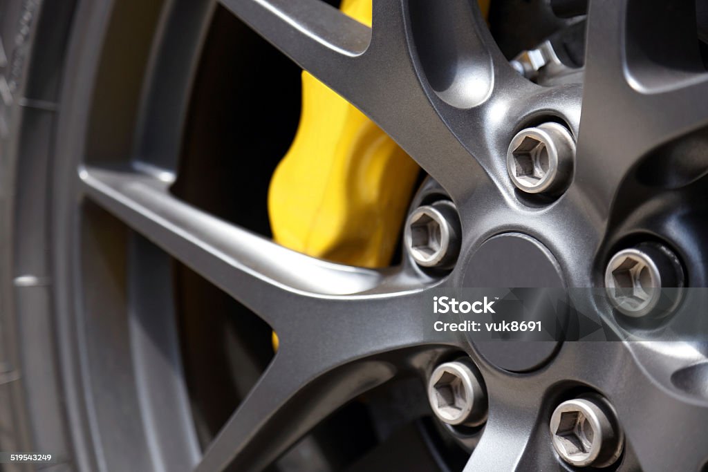 Alloy wheel Details on alloy wheel, the disc brake, brake caliper, nuts and bolts are clear to see. Close-up Stock Photo