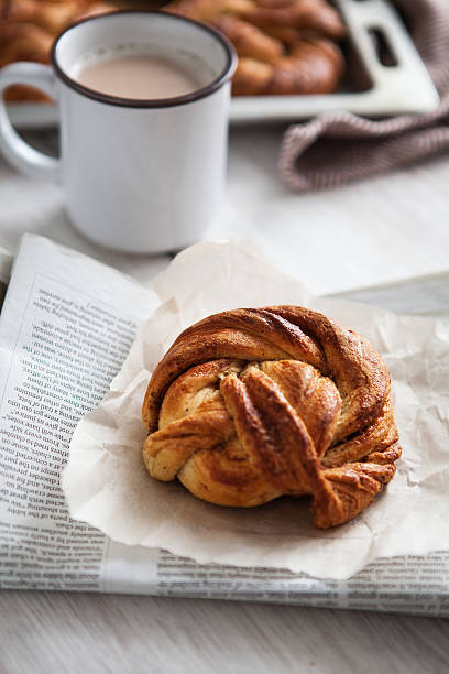 Kanelbulle Swedish bun Kanelbulle Swedish bun and a cup of coffee in natural light kanelbulle stock pictures, royalty-free photos & images