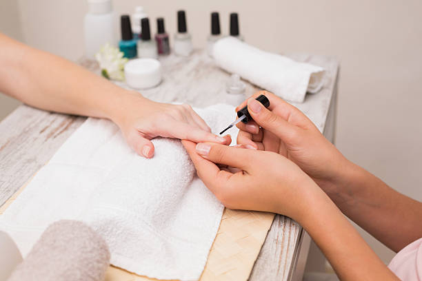 istock Nail technician giving customer a manicure 519544001
