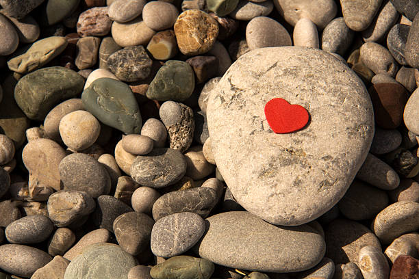 istock pebbles on the beach between the red heart 519545776