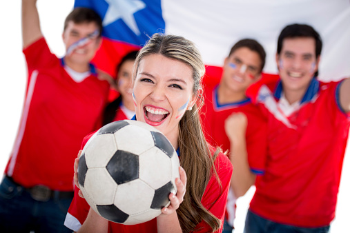 Happy female soccer fan supporting Chile