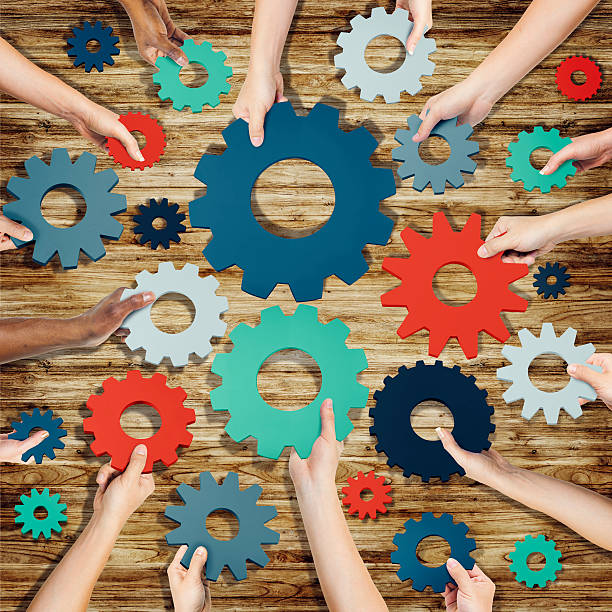 istock Group of Hands Holding Gears Symbol 519547449