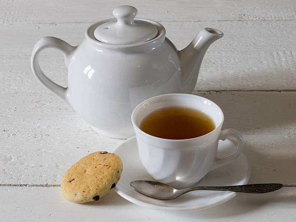 istock cup of green tea, biscuit and kettle 519548322