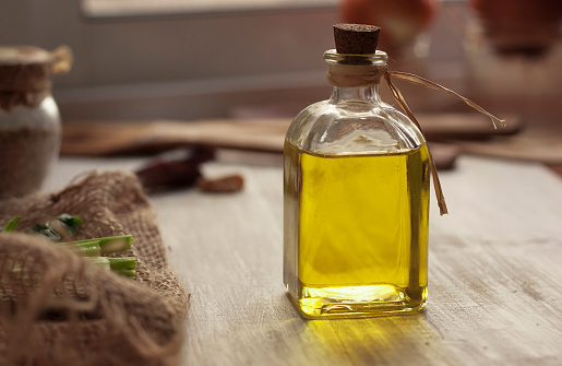 Extra virgin olive oil on rustic background