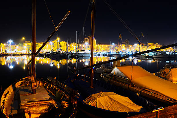 istock boats in Alghero harbor at night 519548932