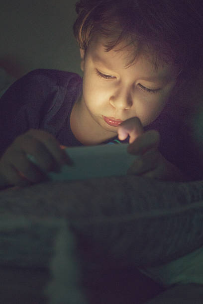 istock little boy with smartphone 519549278