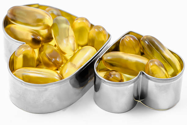 istock Two Fish Oil in Heart shape boxes isolated 519549457