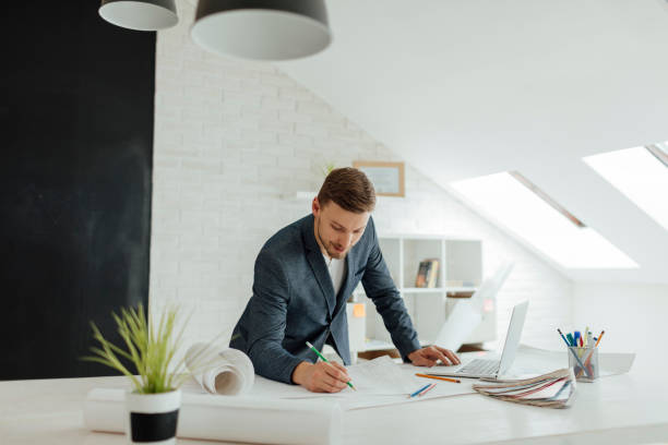 istock Architect Examining Blueprint In The Office. 519550200