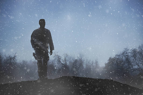 Soldier walks alone through a winter night
