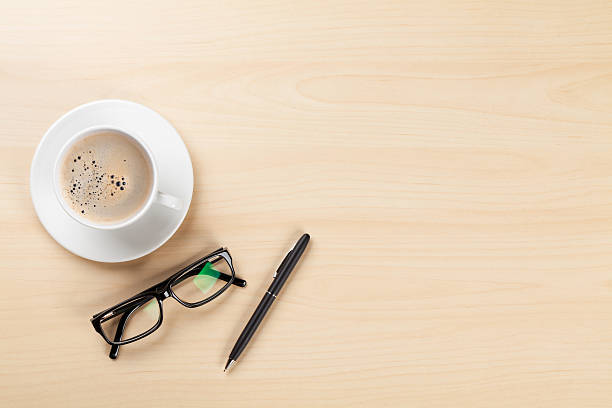 istock Office desk with coffee, pen and glasses 519551060