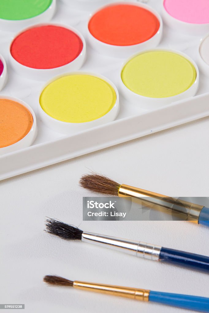 Watercolor Paints Two artist's paintbrushes sit on top of a palette of watercolor paints. Art Stock Photo
