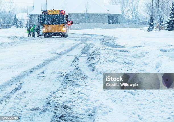 School Students Boarding Blizzard Snow Storm School Bus Stock Photo - Download Image Now
