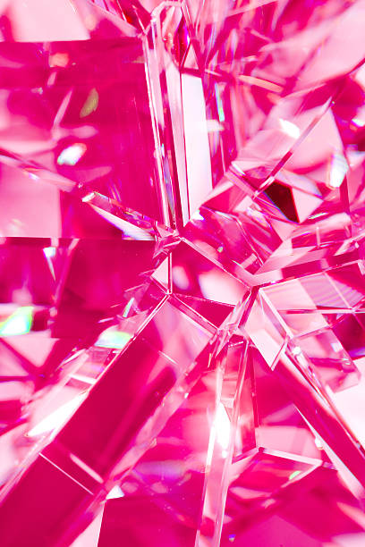 istock pink background of crystal refractions 519556860