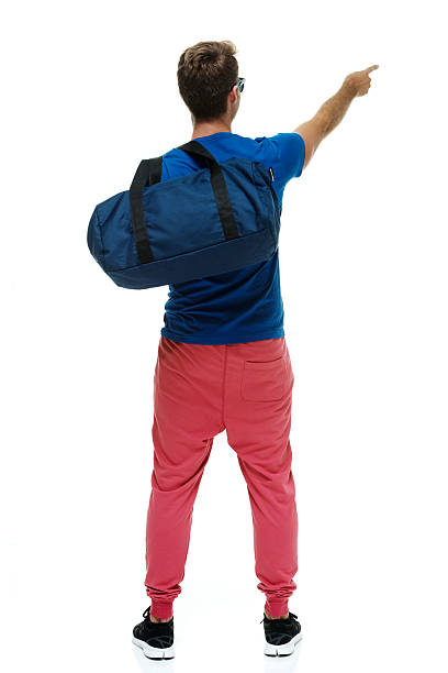 istock Rear view of casual man pointing away 519557364