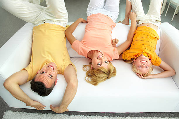 upside down - women group of people lying down mother stock-fotos und bilder