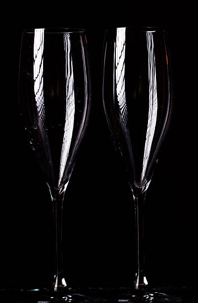 istock champagne glasses on black spray 519558213