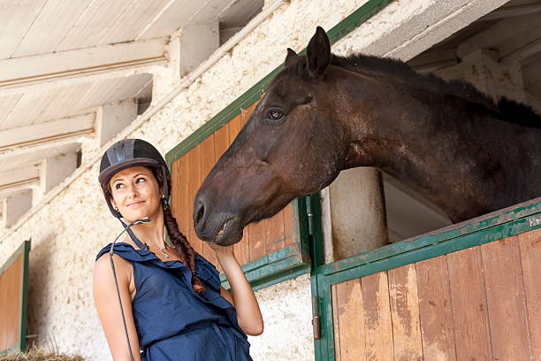 istock horsewoman with his horses 519558421