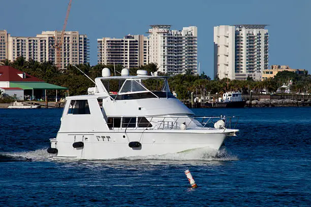 Luxury yatch in the intercoastal waterway with  West Palm Beach, Florida in the background.
