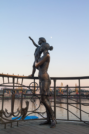 Odessa, Ukraine - August 24, 2015: Statue of mother and son greeting the sailor on the pier