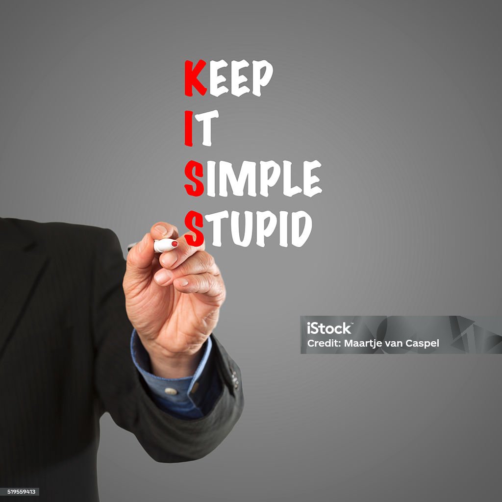 Business man hand writing KISS principle Male hand in business wear holding a thick pen, writing the terms leading to the KISS principle Adult Stock Photo