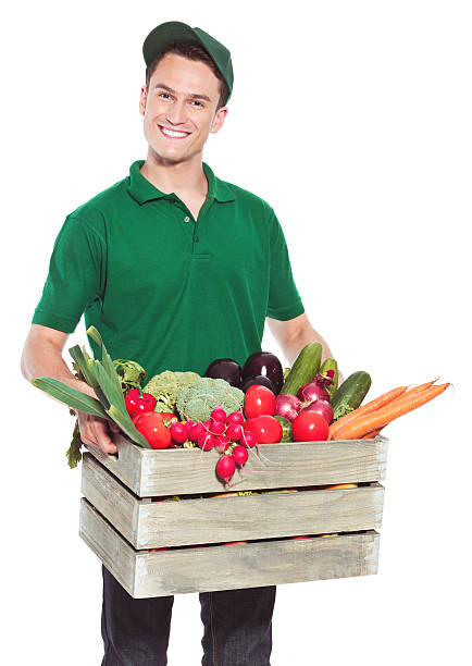 homem de entrega com alimentos orgânicos - vegan food cheerful vertical indoors - fotografias e filmes do acervo