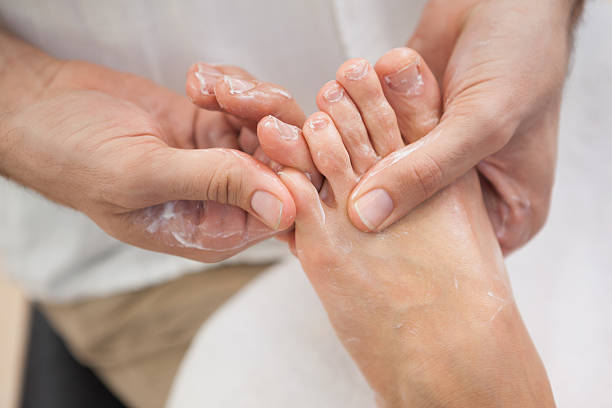 istock Pedicurist massaging customers foot 519561189