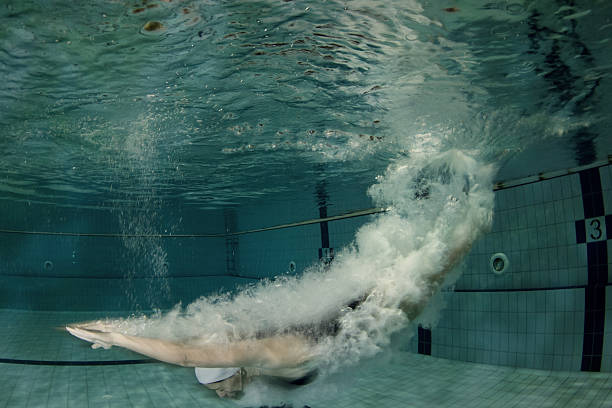 istock Attractive young woman swimming under the water surface 519561695