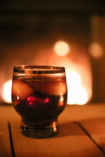glass of mulled wine on a background of fire